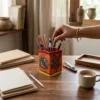 orange madhubani art pen stand in use
